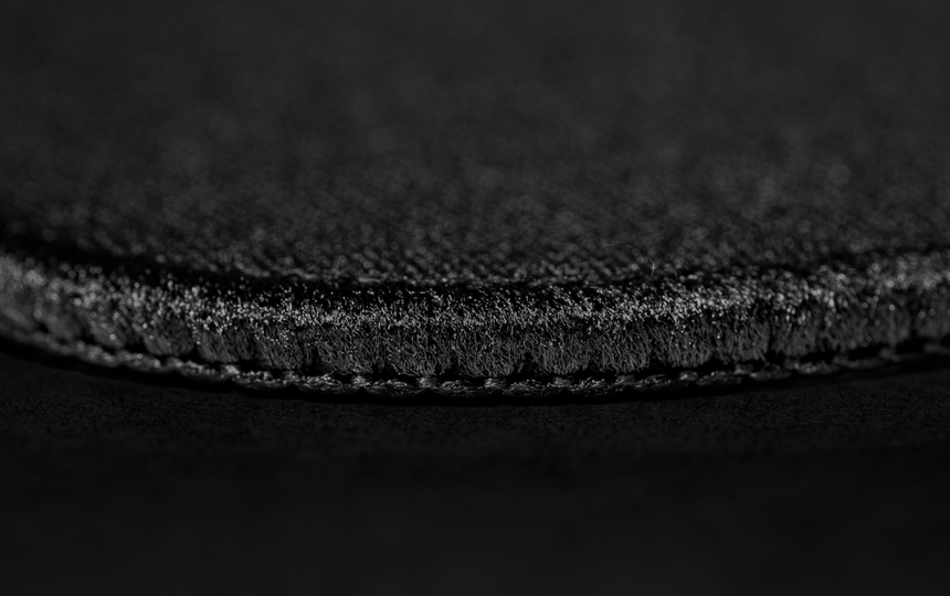 A close-up image showing the edge stitching of the mousepad.